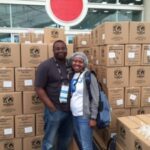 ActioNeters Smile and Pose for Photos in Front of Packed Meals