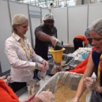 Cisco Live Volunteers Use Teamwork to Pack Meals