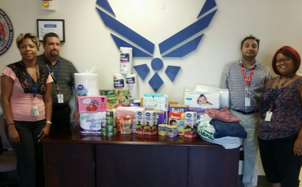 ActioNeters pose with goods they donated to help Louisiana flood victims