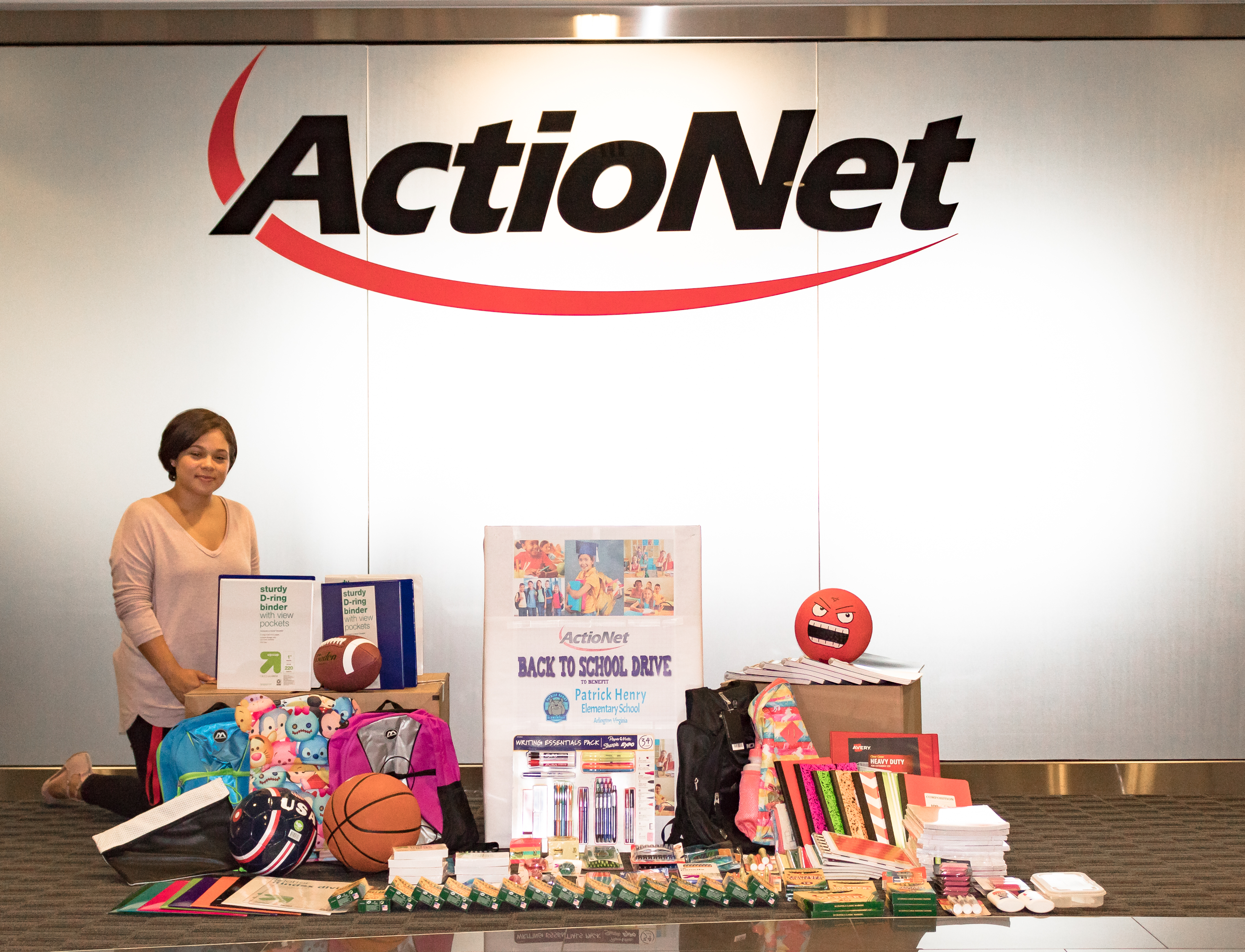 ActioNeter Alexis poses with the donations to our Back to School Drive