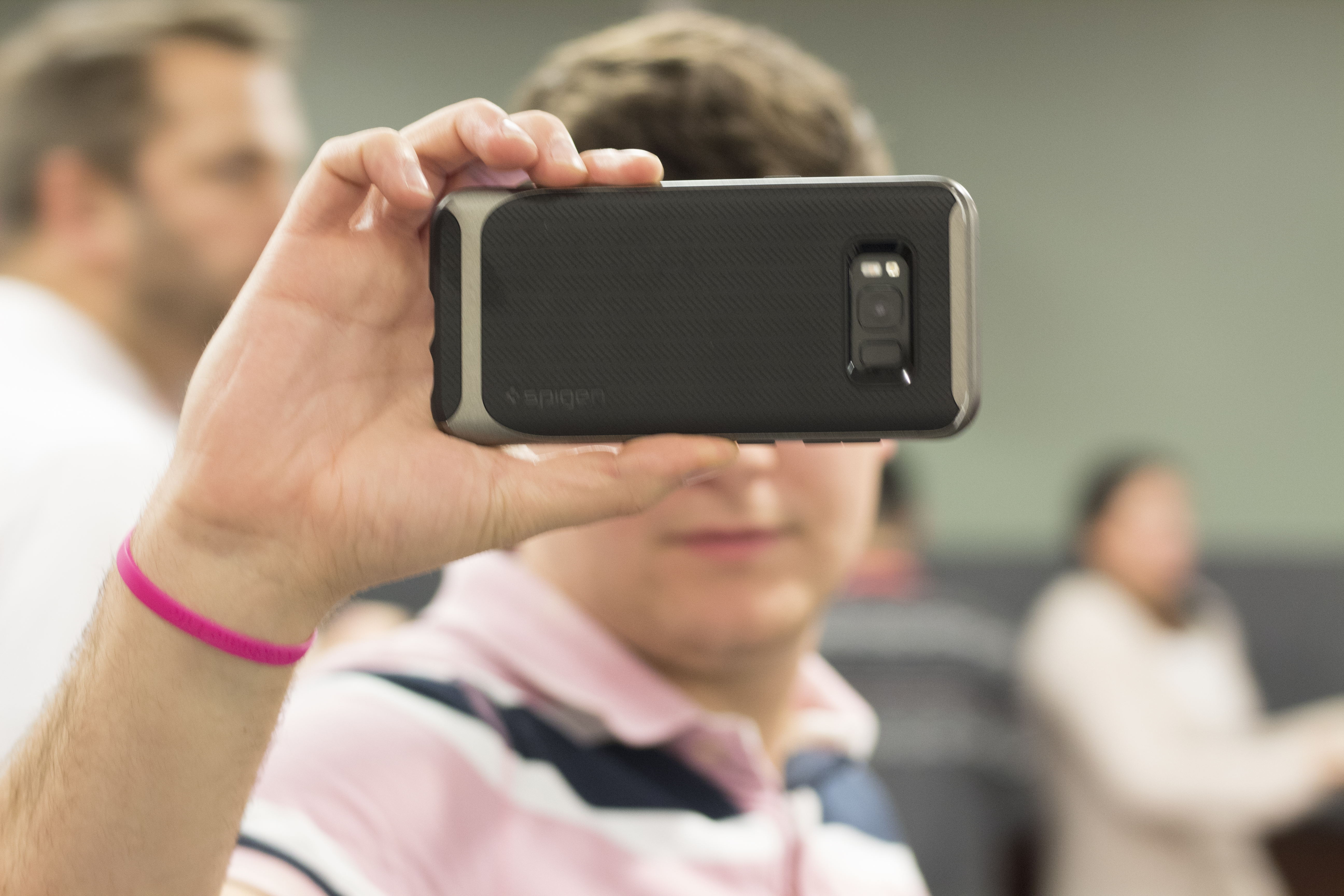 ActioNeter taking photos with his phone at the monthly birthday event