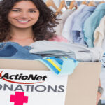 Pretty volunteer holding clothes donation box