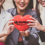 Businesswoman team giving a red heart to a customer on isolated