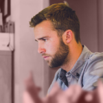 Man on computer with office supplies – LINKEDIN