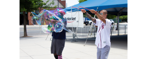 ActioNeters Bobby and Tony Create Giant Bubbles to Welcome Attendees to the ActioNet HQ Summer Picnic