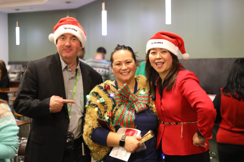 Ugly Sweater Winner Maricar shows off her Ugly Sweater with CEO Ashley and VP Jeff