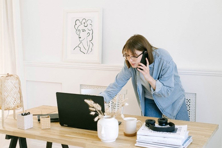 Woman stands up while on a phone meeting